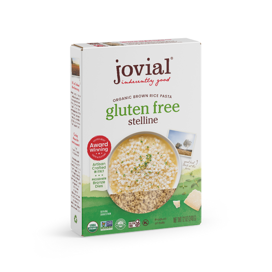 Jovial Gluten Free Brown Rice Stelline pasta in a white bowl, showing small, star-shaped pasta pieces on a neutral background.
