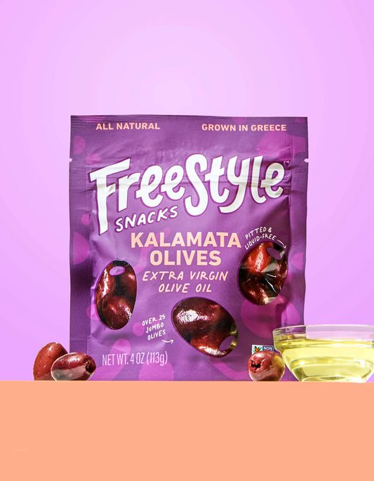 Close-up of Freestyle Snacks Kalamata olives in extra virgin olive oil, showing glossy dark purple olives in a clear bowl.