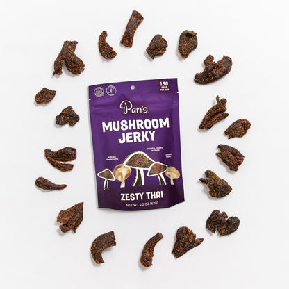 Close-up of Pan's Zesty Thai Mushroom Jerky, a savory snack food with sliced mushrooms seasoned with Thai spices.