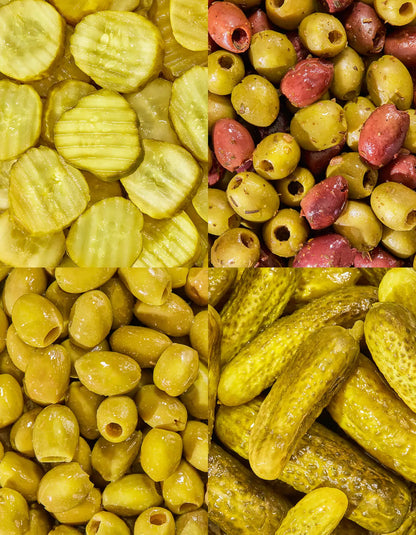 Assorted olives and pickles from FreeStyle Snacks The Party Pack, featuring a variety of snack jars on a wooden table.