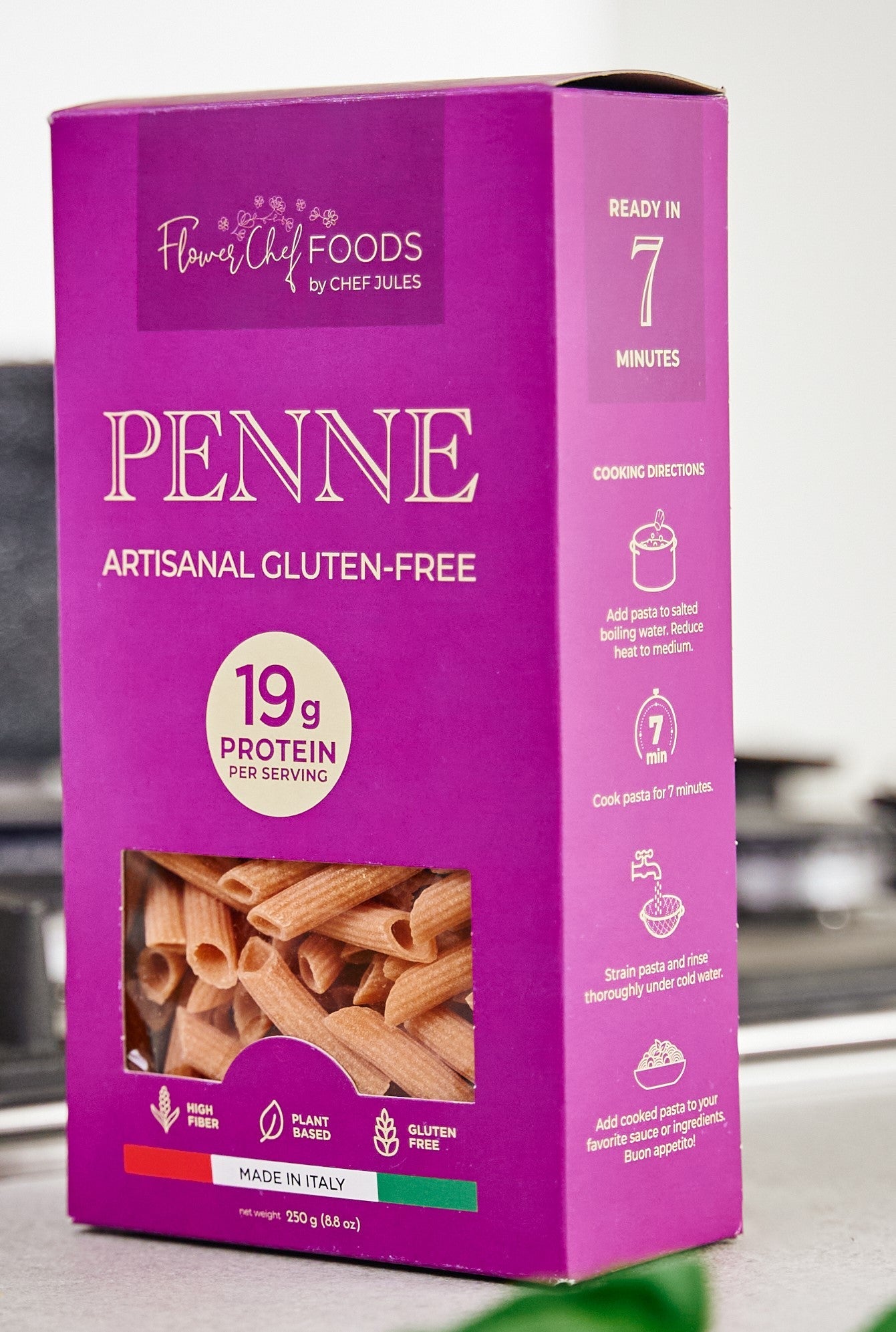 High-protein Flower Chef Foods penne pasta in a clear container, showcasing the pasta's ridged, tubular shape.