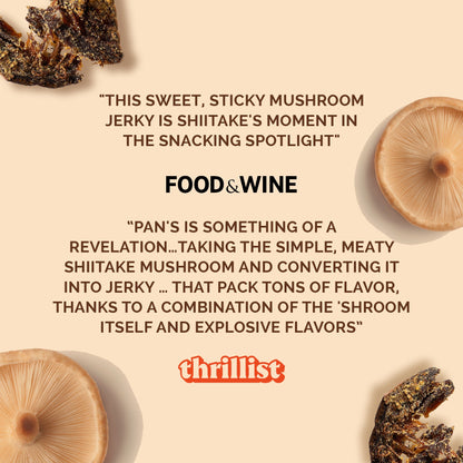 Pan's Mushroom Jerky salt and pepper mushroom jerky slices on a wooden surface, showcasing the savory snack's texture and seasoning.