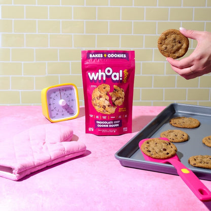 Raw Whoa Dough Ready to Bake Chocolate Chip cookie dough in a stylized package, ready for baking and enjoying fresh cookies.