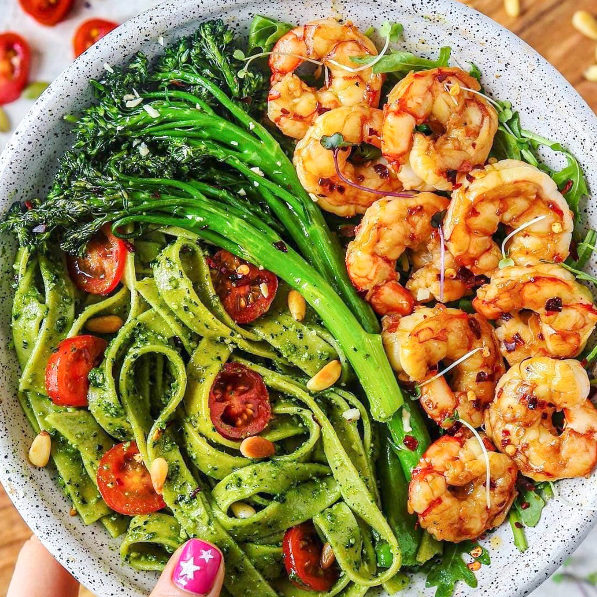 Fresh gluten-free spinach fettuccine pasta from Taste Republic Gluten-Free, shown in a 6-pack with cooked noodles and spinach leaves.
