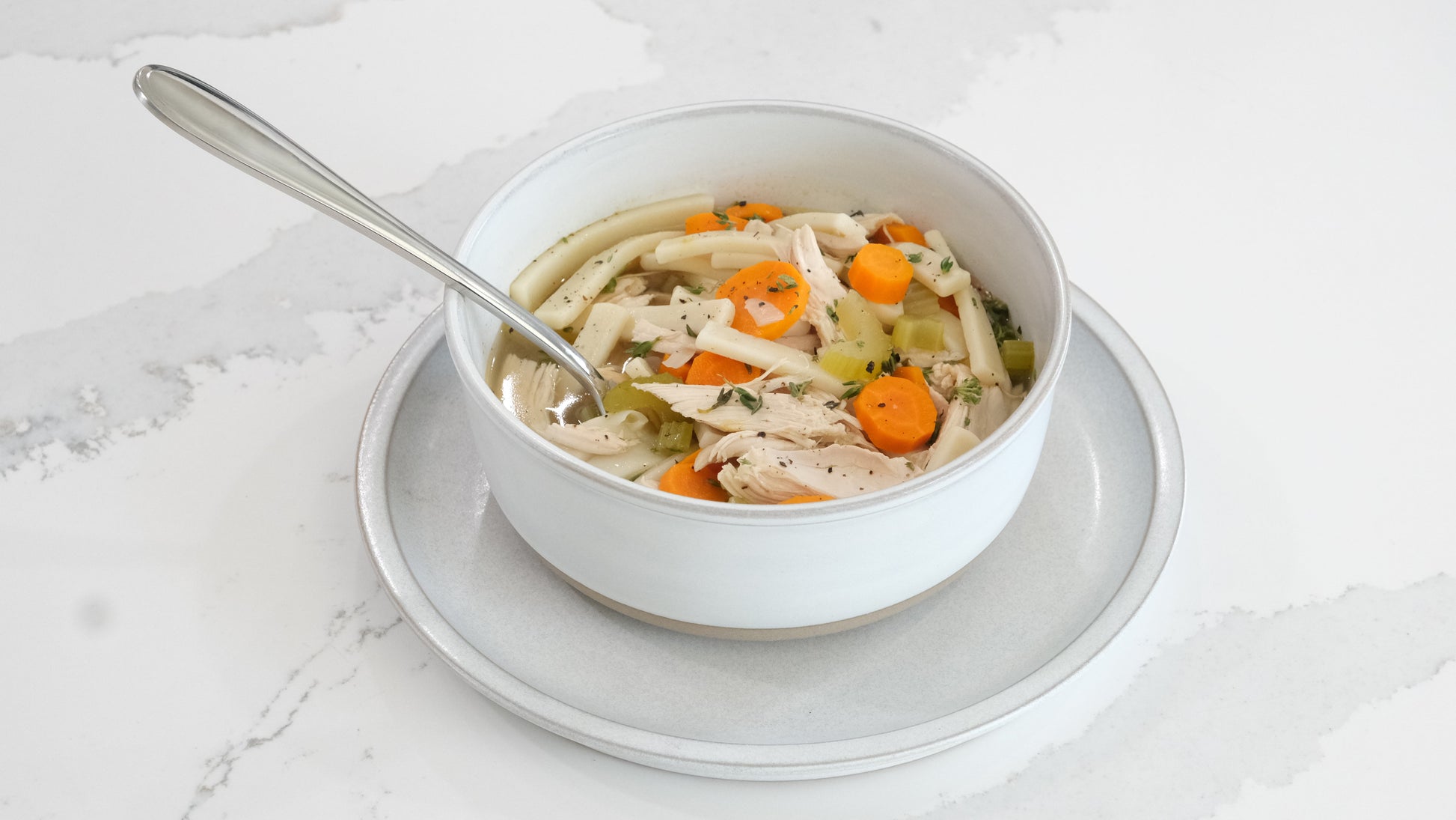 Taste Republic gluten-free egg noodle pasta in 16oz packages, displayed in a family-sized frozen food setting.