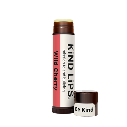 Kind Lips Wild Cherry organic lip balm tube with cherry flavor and natural ingredients, displayed on a neutral background.