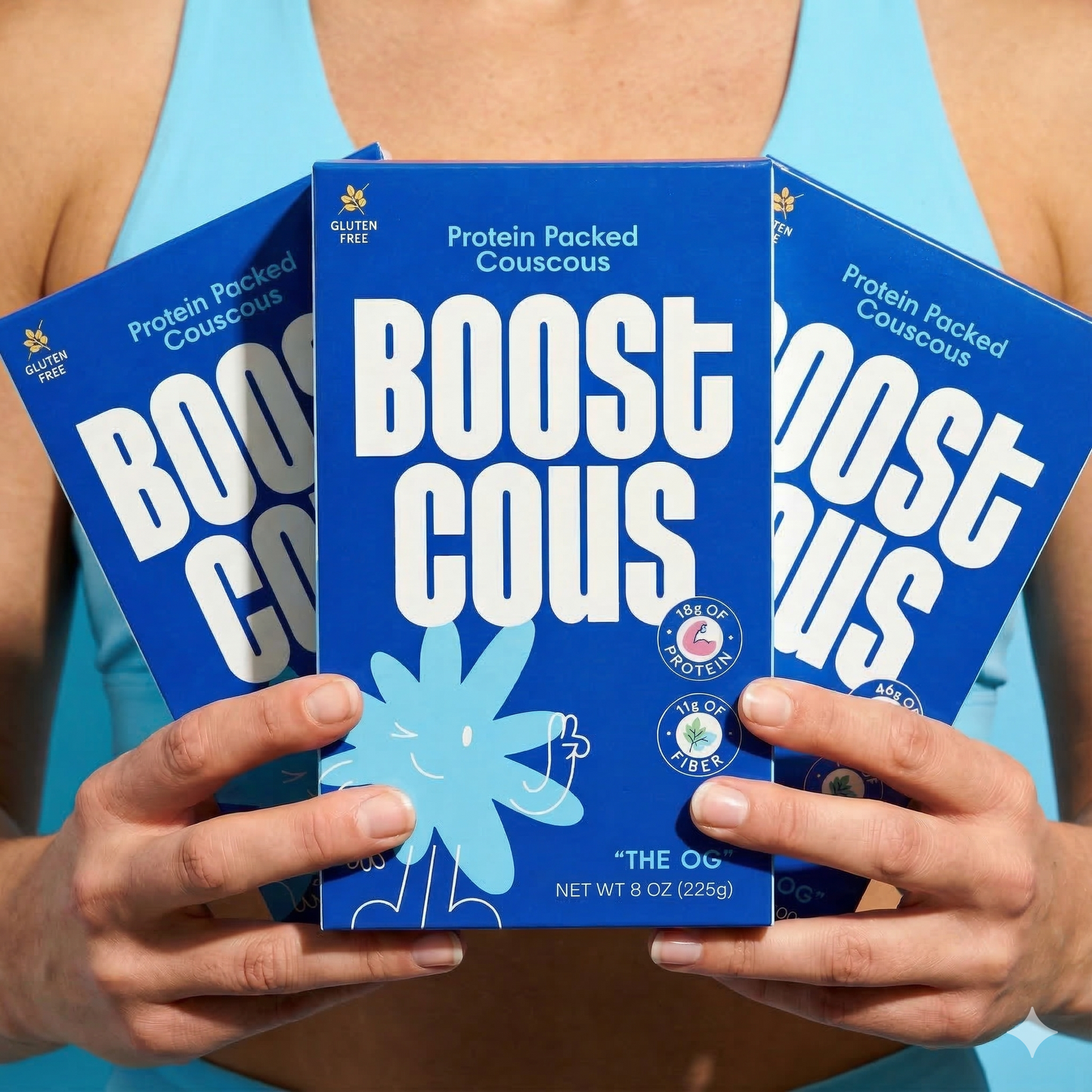 Women holding boxes of Boostcous The OG Protein Packed Couscous, a healthy, high-protein grain product by boostcous.