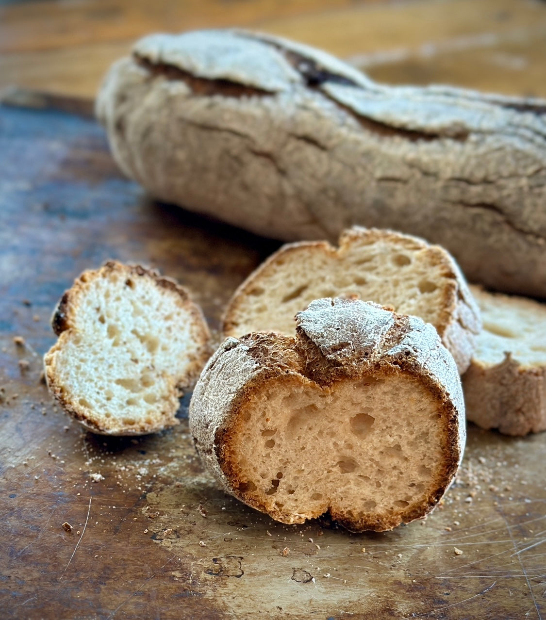 Slices of gluten-free bread made from gfJules gluten free bread mix, showcasing a crispy, golden baguette.