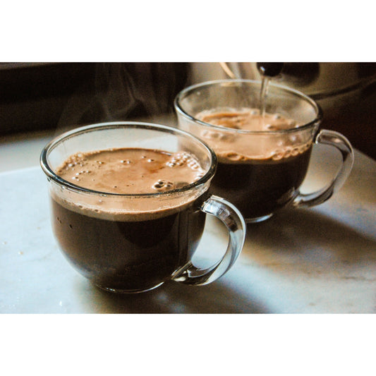Single-serving Bare Life dairy-free coconut hot cocoa mix packets, featuring rich cocoa in convenient individual packages.