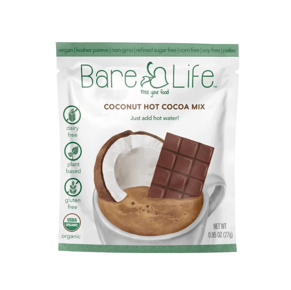 Bare Life dairy-free coconut hot cocoa mix single serving packets, showing the packaging with cocoa powder and coconut flavor.