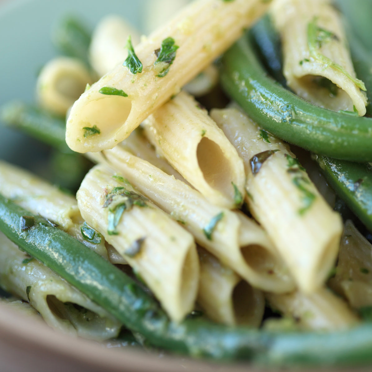 Jovial Gluten Free Brown Rice Penne pasta in a single serving container, showcasing the uncooked whole brown rice penne.
