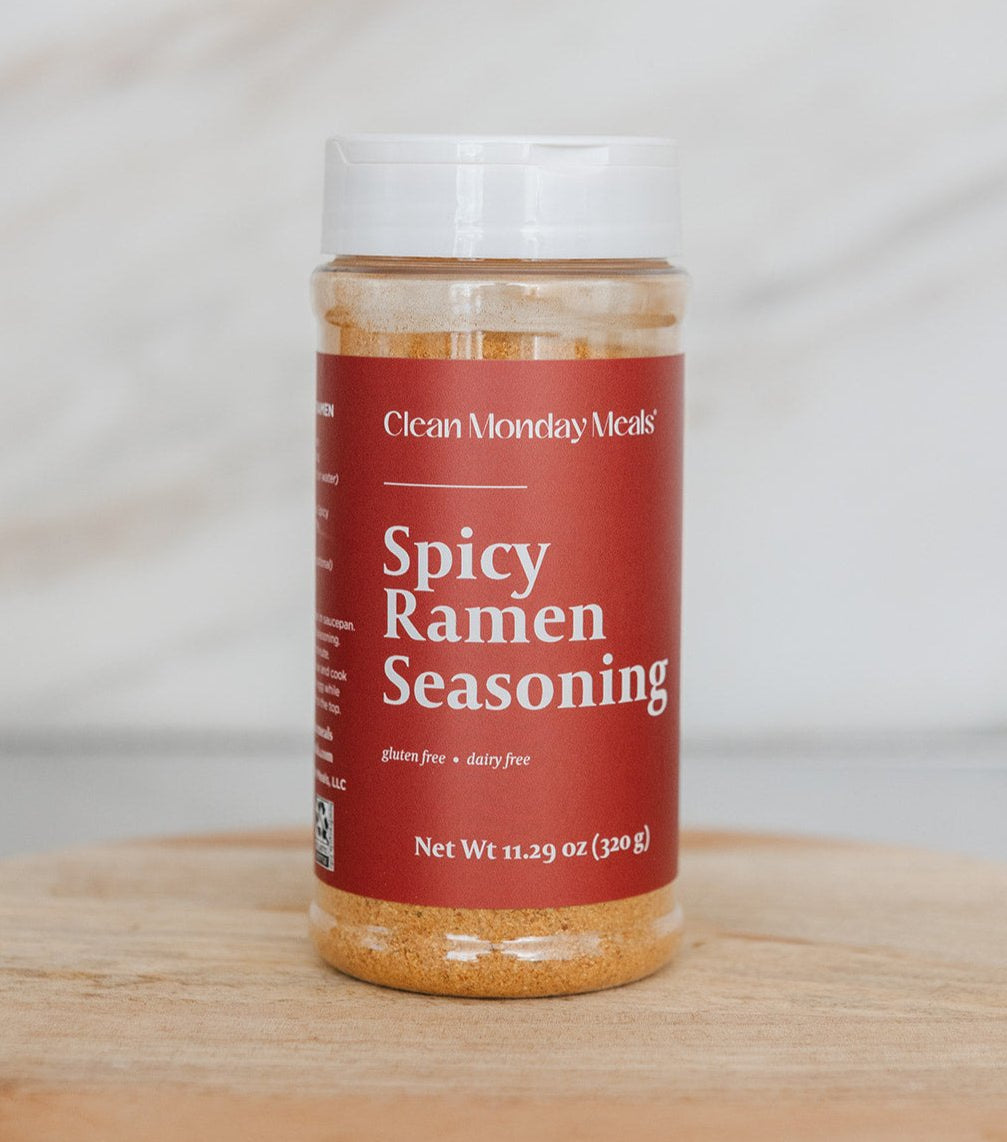 Spicy ramen seasoning packet from Clean Monday Meals, featuring vibrant red and orange packaging with a bowl of spicy ramen noodles.