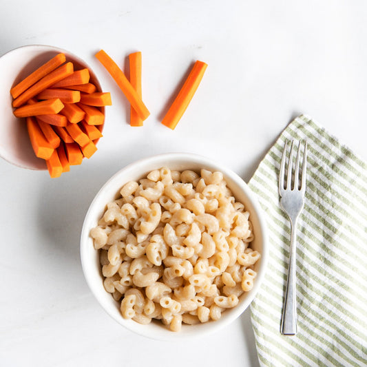 Gluten-free vegan Jovial Mac with dairy-free ingredients, featuring a creamy pasta dish in a natural setting.