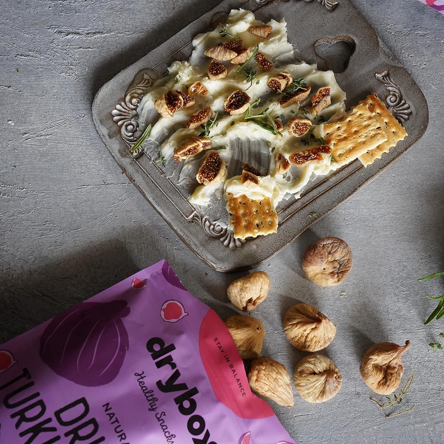 Three dried Turkish figs from drybox, showcasing their wrinkled texture and rich brown color in a close-up image.
