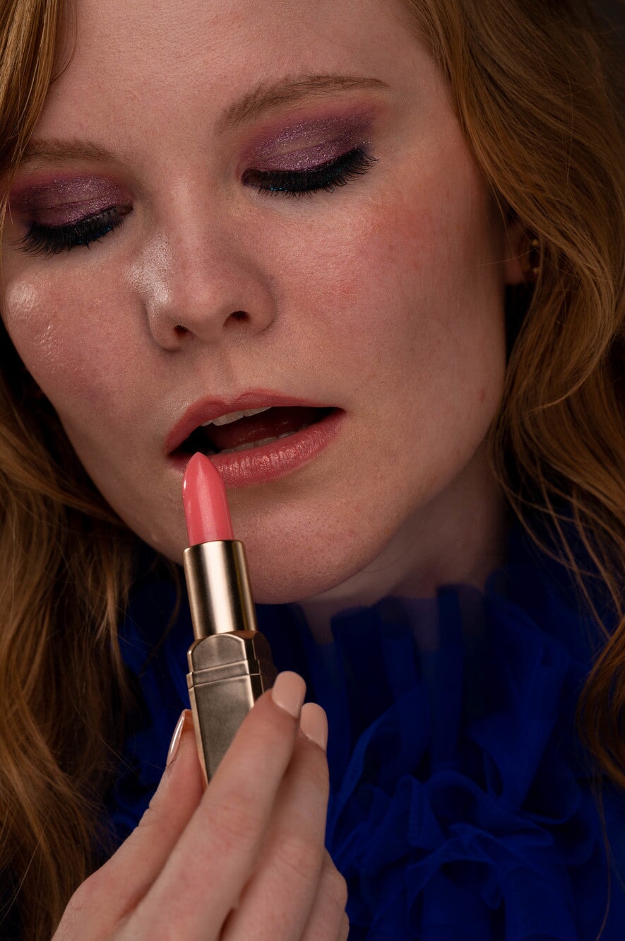 EpiLynx Color-Changing Flower Lip Gloss in a clear tube, showing vibrant, hydrating vegan lip balm with a flower design.