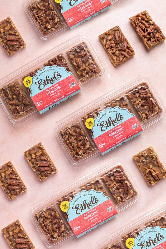 Ethel's Pecan Dandy Bar dessert set from Ethels Baking Company, featuring golden pecan-filled chocolate-covered bars.