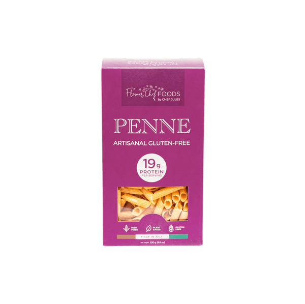 High protein Flower Chef Foods penne pasta in a clear bowl, showcasing the textured, uncooked pasta with a golden color.