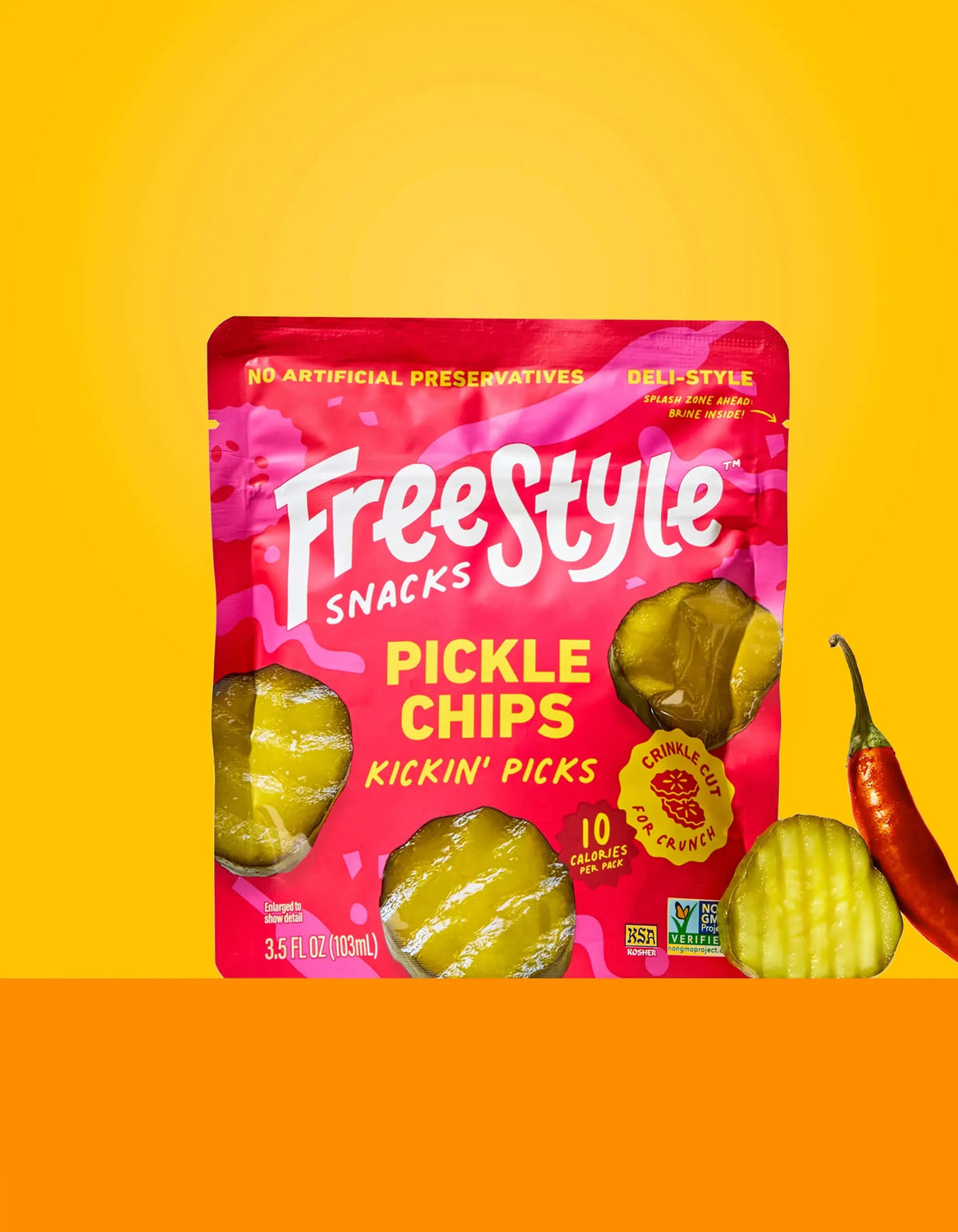 Freestyle Snacks Kickin' Picks Pickle Chips in a clear bowl, showing crispy, sliced pickle chips with spices on a white background.