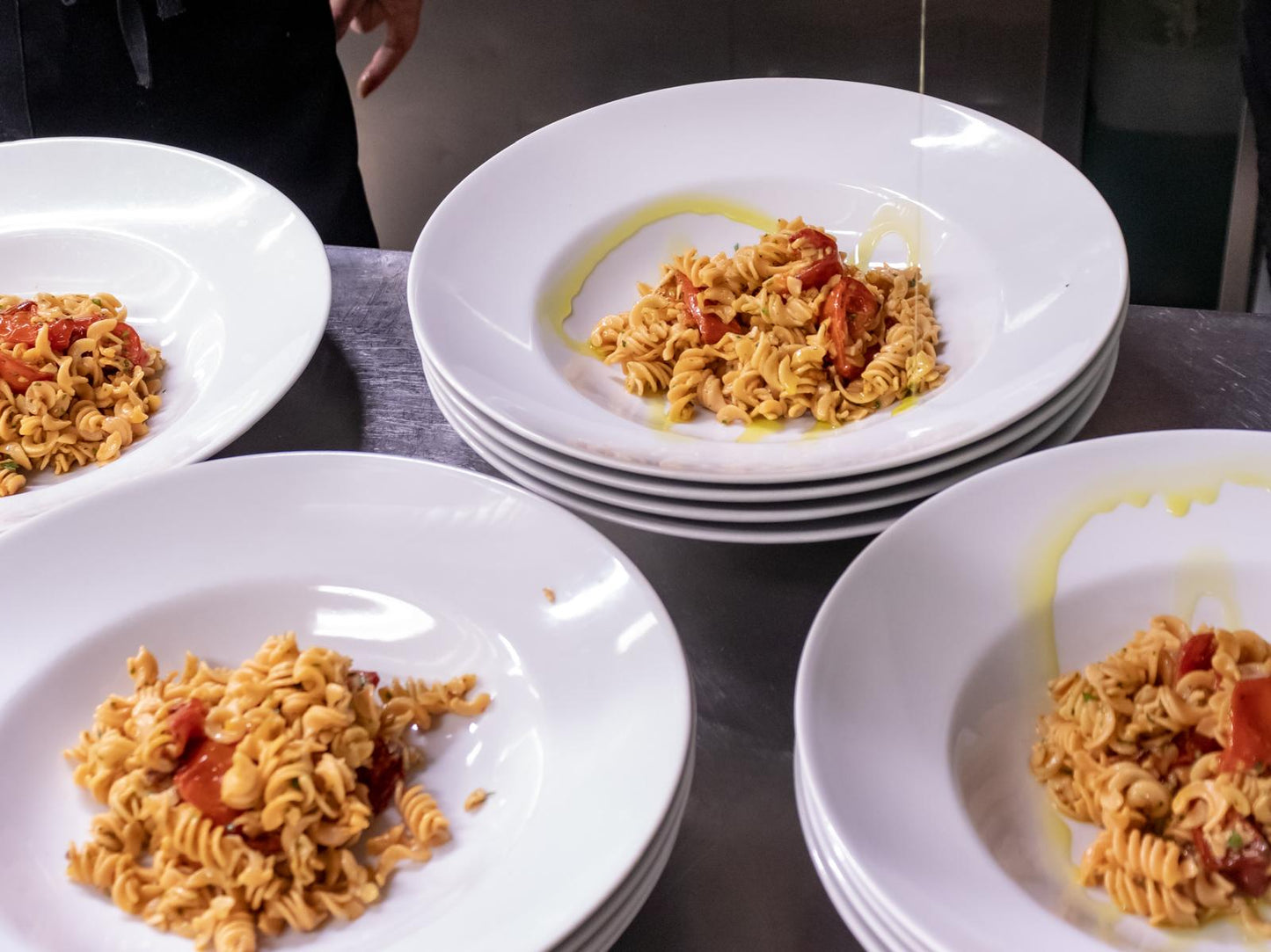 Cooked Flower Chef Foods high protein fusilli pasta served on dinner plates, ready to enjoy a nutritious meal.