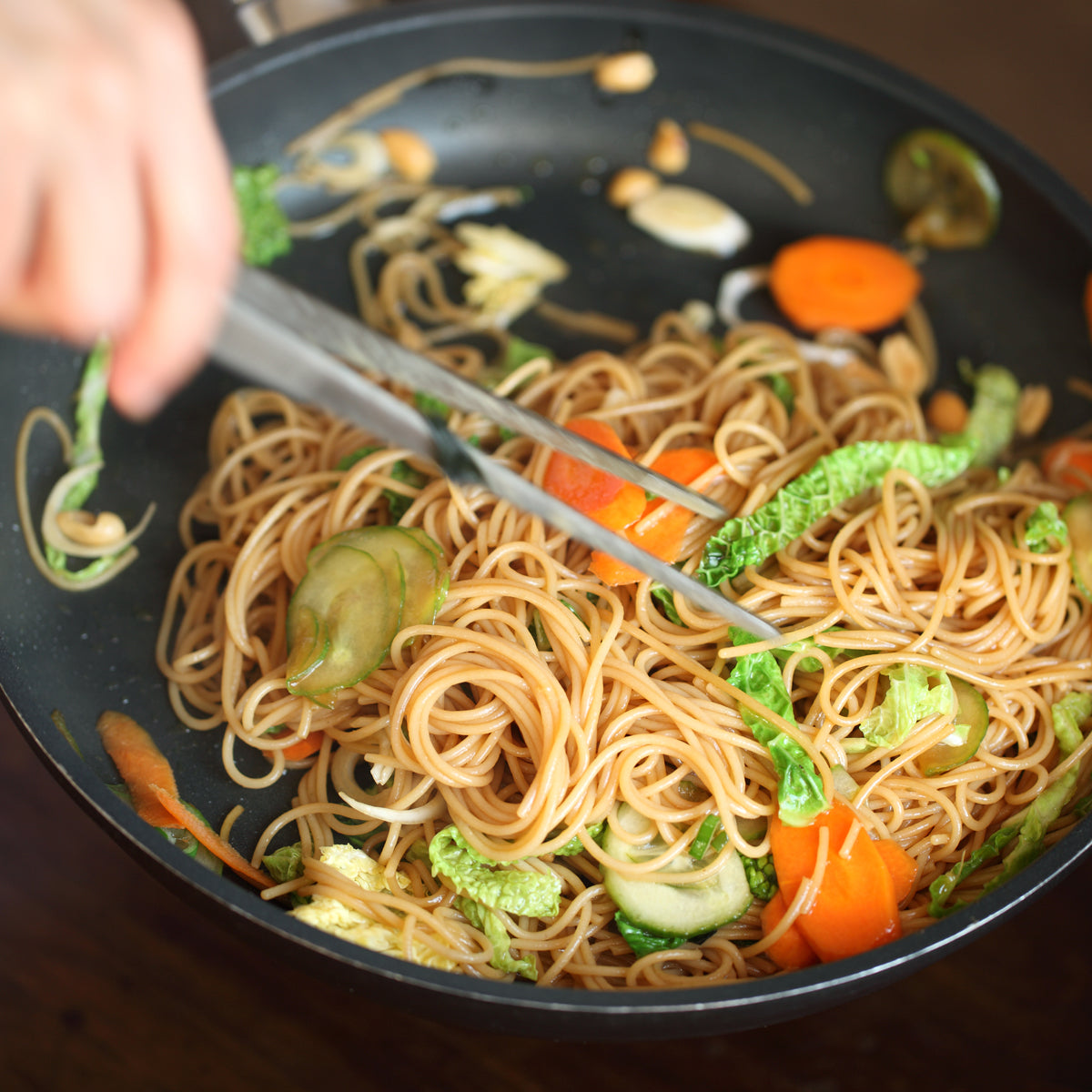 Jovial Gluten-Free Brown Rice Capellini pasta in a clear package, showcasing thin, light brown rice noodles on a white background.