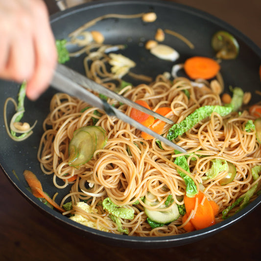 Jovial Gluten-Free Brown Rice Capellini pasta in a clear package, showcasing thin, light brown rice noodles on a white background.
