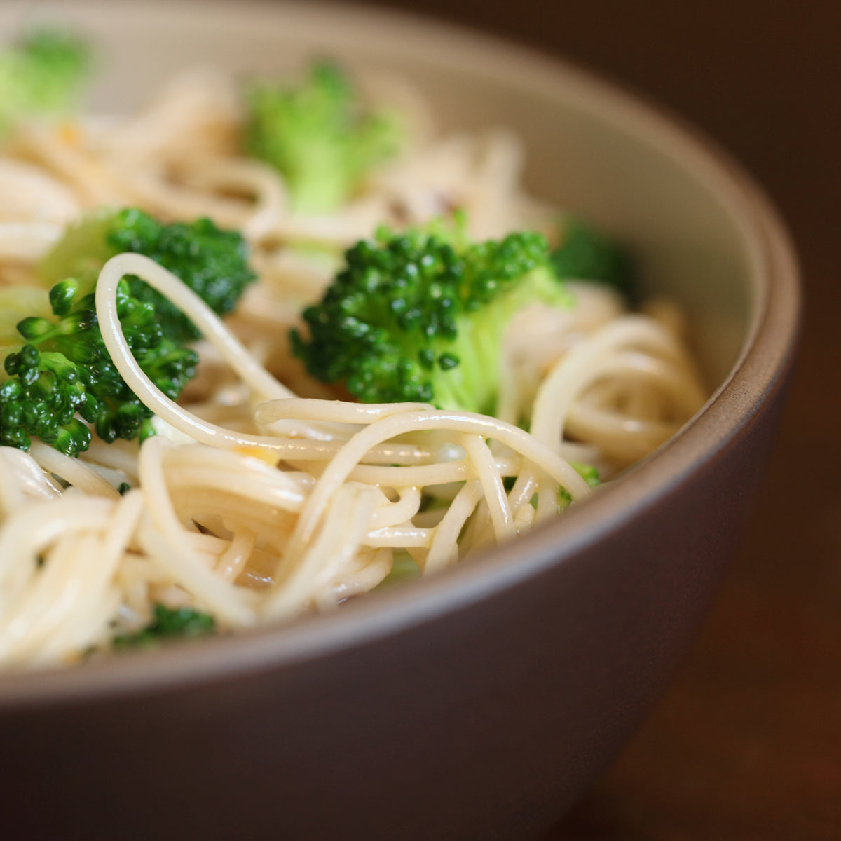 Jovial Gluten Free Brown Rice Capellini pasta with broccoli, cooked and plated, showcasing a healthy gluten-free meal.