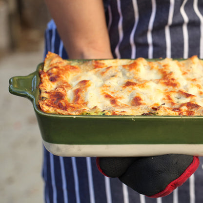 Gluten-free Jovial brown rice lasagna with visible layers of vegetables and melted cheese in a baking dish.
