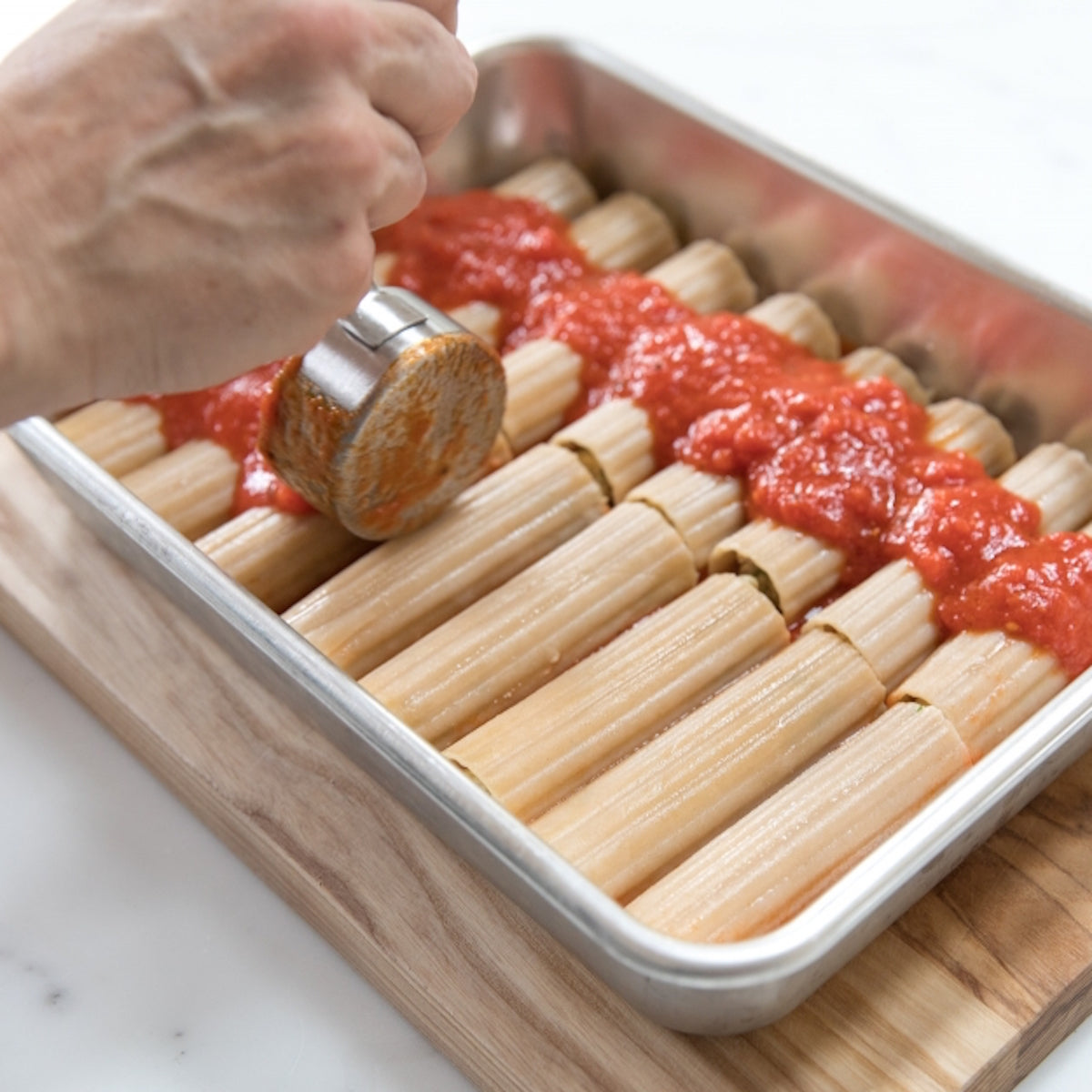 Gluten-free Jovial Brown Rice Manicotti pasta shells on a white background, showcasing the product's shape and texture.