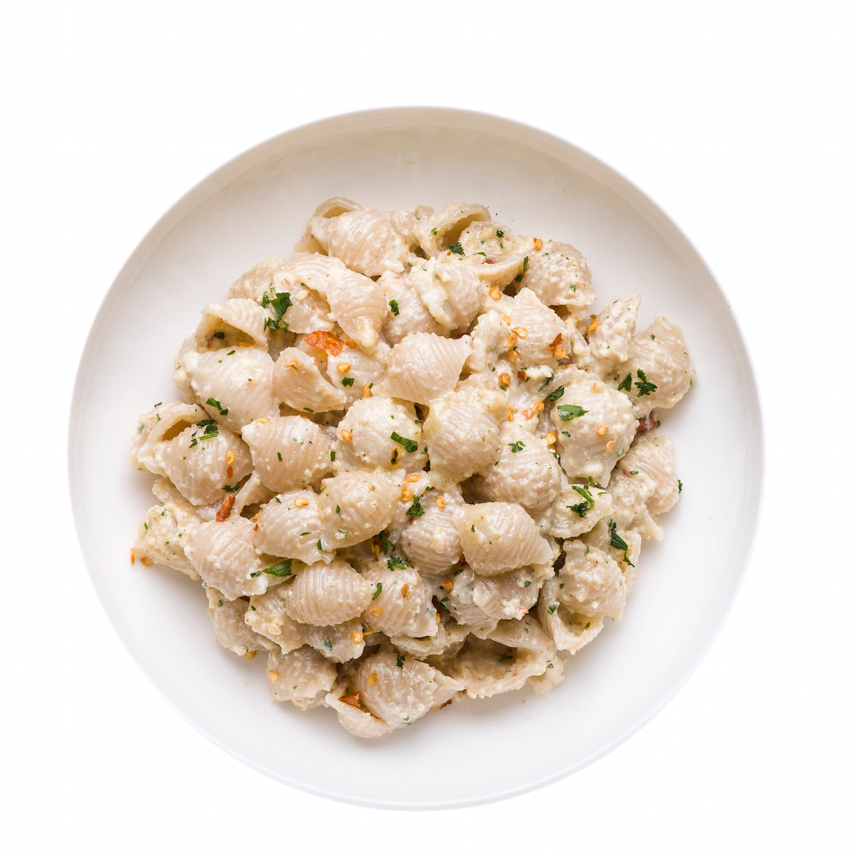 Gluten-free Jovial Brown Rice Shells pasta in a bowl, showcasing the light brown, textured rice shell shape on a white background.