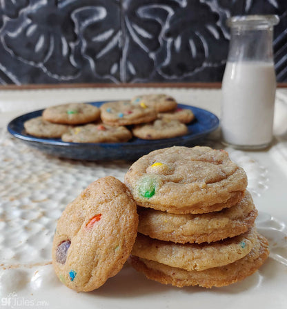 Stack of gfJules gluten-free cookie mix cookies on a baking sheet, showcasing freshly baked, golden-brown cookies.