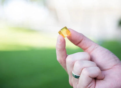 Essential Candy Ginger Green Tea botanical lozenges in clear hard candy form with green tea and ginger blend visible.