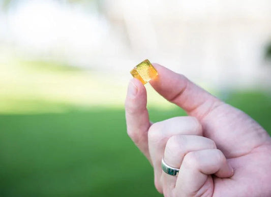 Essential Candy Ginger Green Tea botanical lozenges in clear hard candy form with green tea and ginger blend visible.