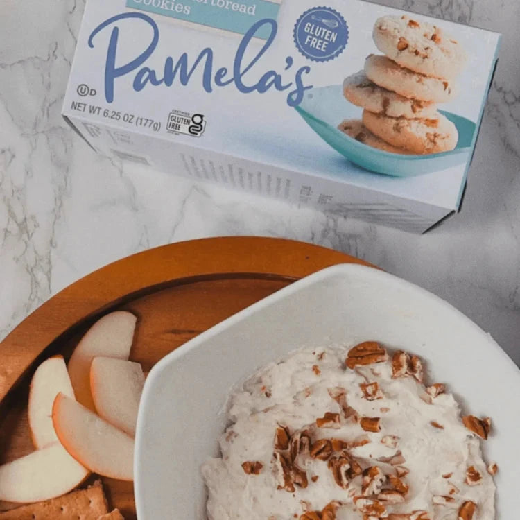 Assorted Pamela's Products gluten-free pecan shortbread cookies in a variety bundle, displayed on a rustic wooden surface.
