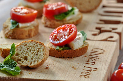 Gluten-free baguette topped with fresh basil and melted mozzarella cheese, made with gfJules Gluten Free Bread Mix.