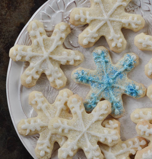 gfJules gluten-free cut-out cookie mix with decorated cookies and snowflake designs on a plate.