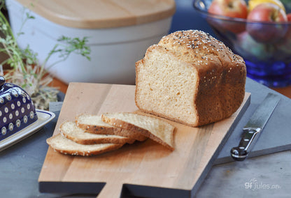 Slice of gfJules gluten-free sandwich bread showing soft, airy texture and golden crust, perfect for gluten-free sandwiches.