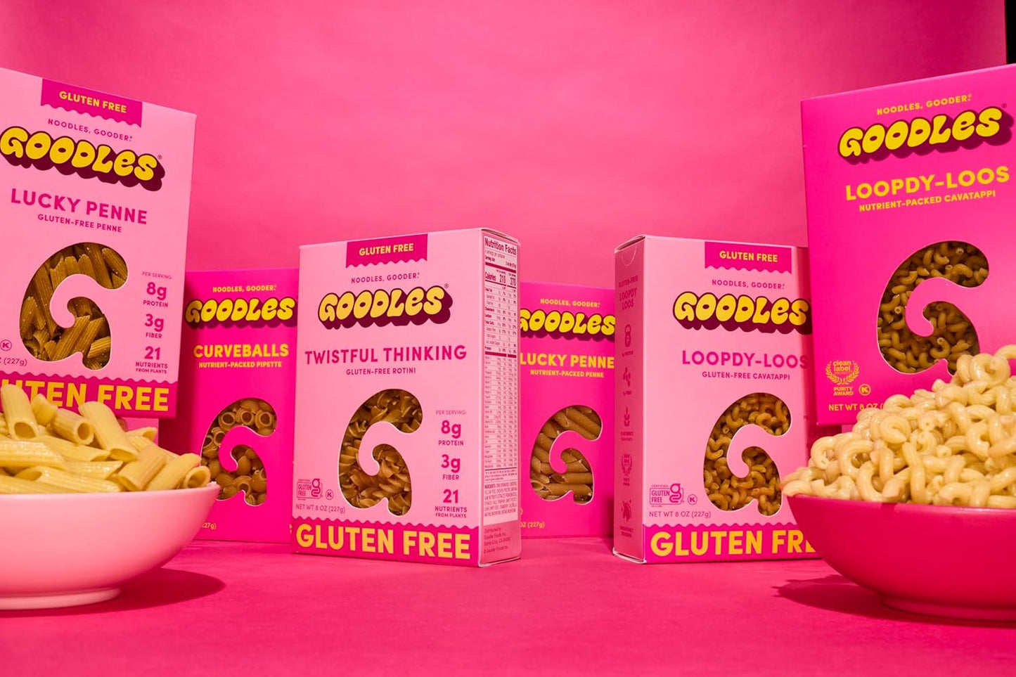 A bowl of Goodles Pink Noodles with vibrant pink pasta topped with herbs, showcasing a colorful, appetizing meal from Goodles.