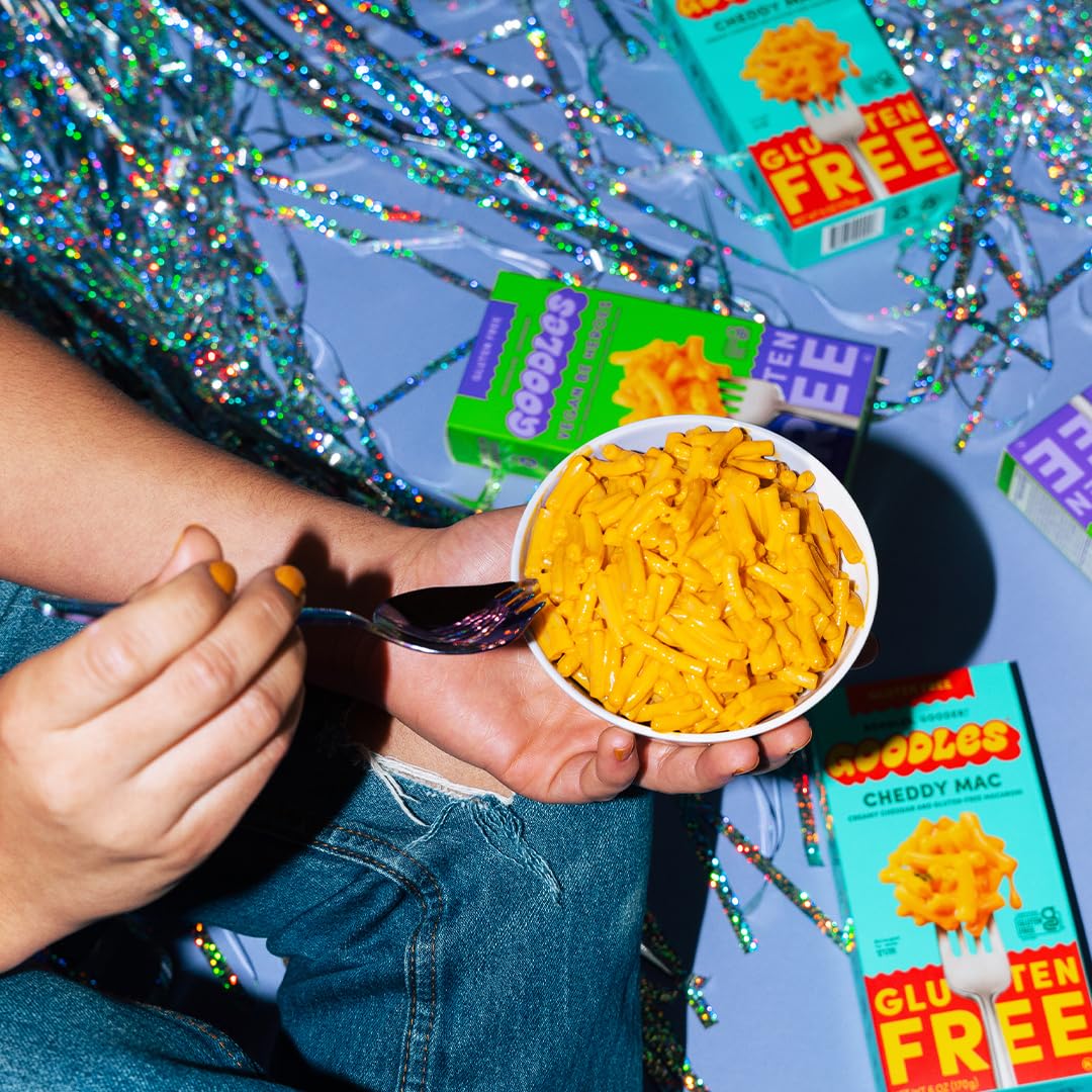 Creamy Cheddy Mac pasta from Goodles featuring gooey cheese, served in a bowl with a fork, highlighting the product's cheesy texture.
