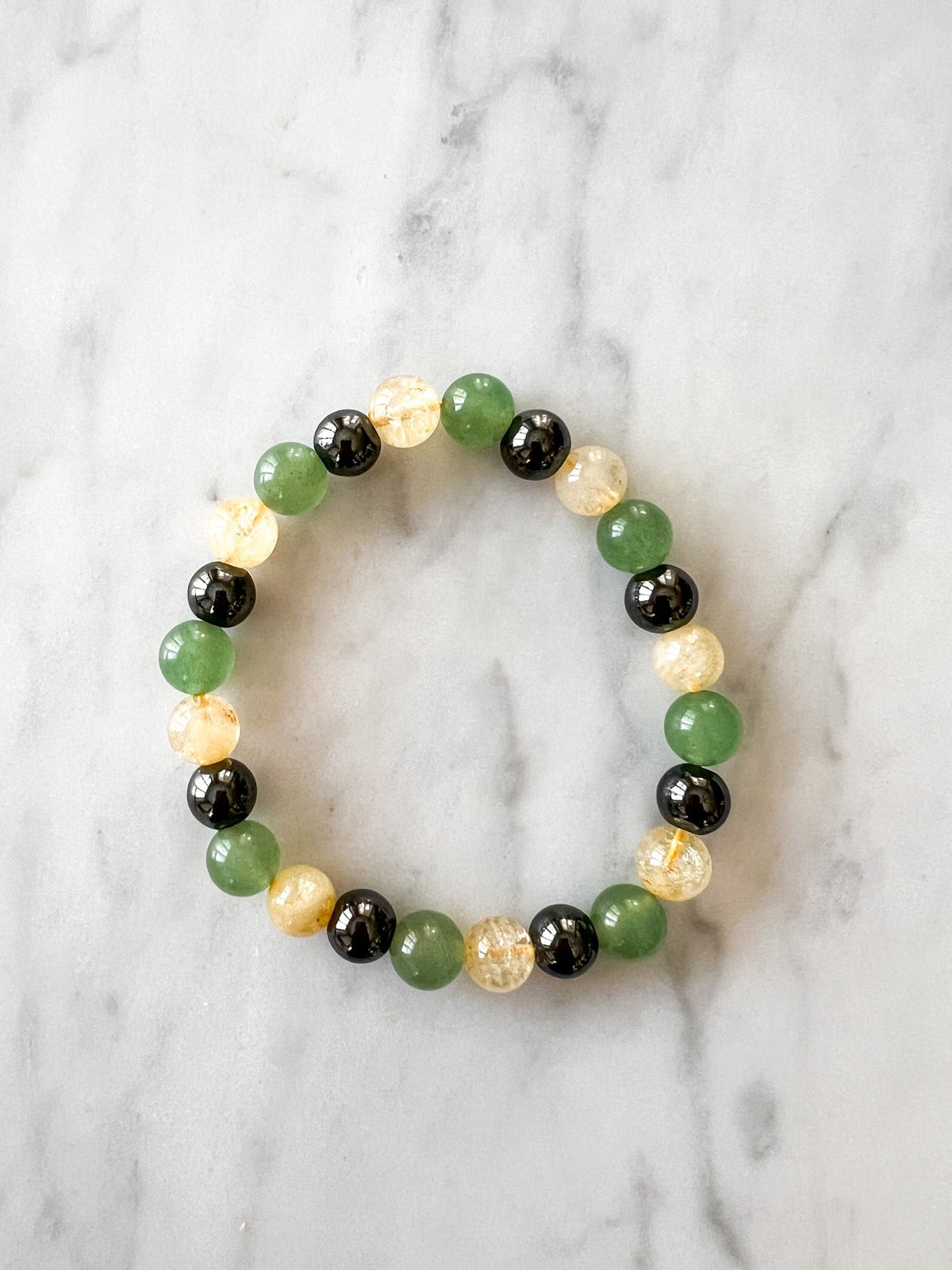 Healing bracelet with citrine and green aventurine beads from Love Me Gluten Free, showcasing vibrant gemstone details.