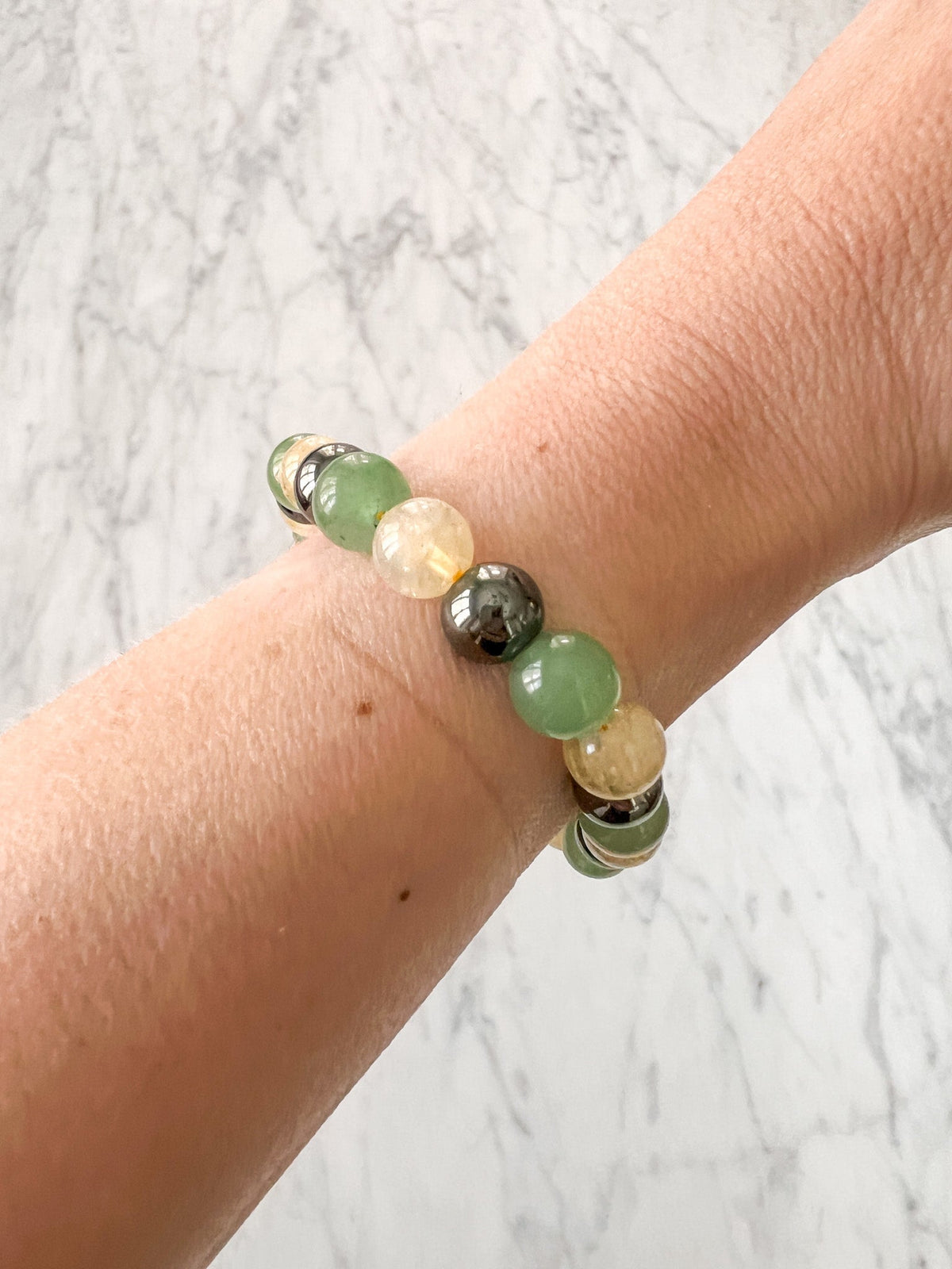 Healing bracelet featuring citrine and green aventurine stones, designed for wellness and positive energy.