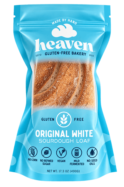 Four slices of Heaven GF Bakery Buckwheat White Sourdough Vegan Loaf, gluten-free sourdough bread on a wooden board.