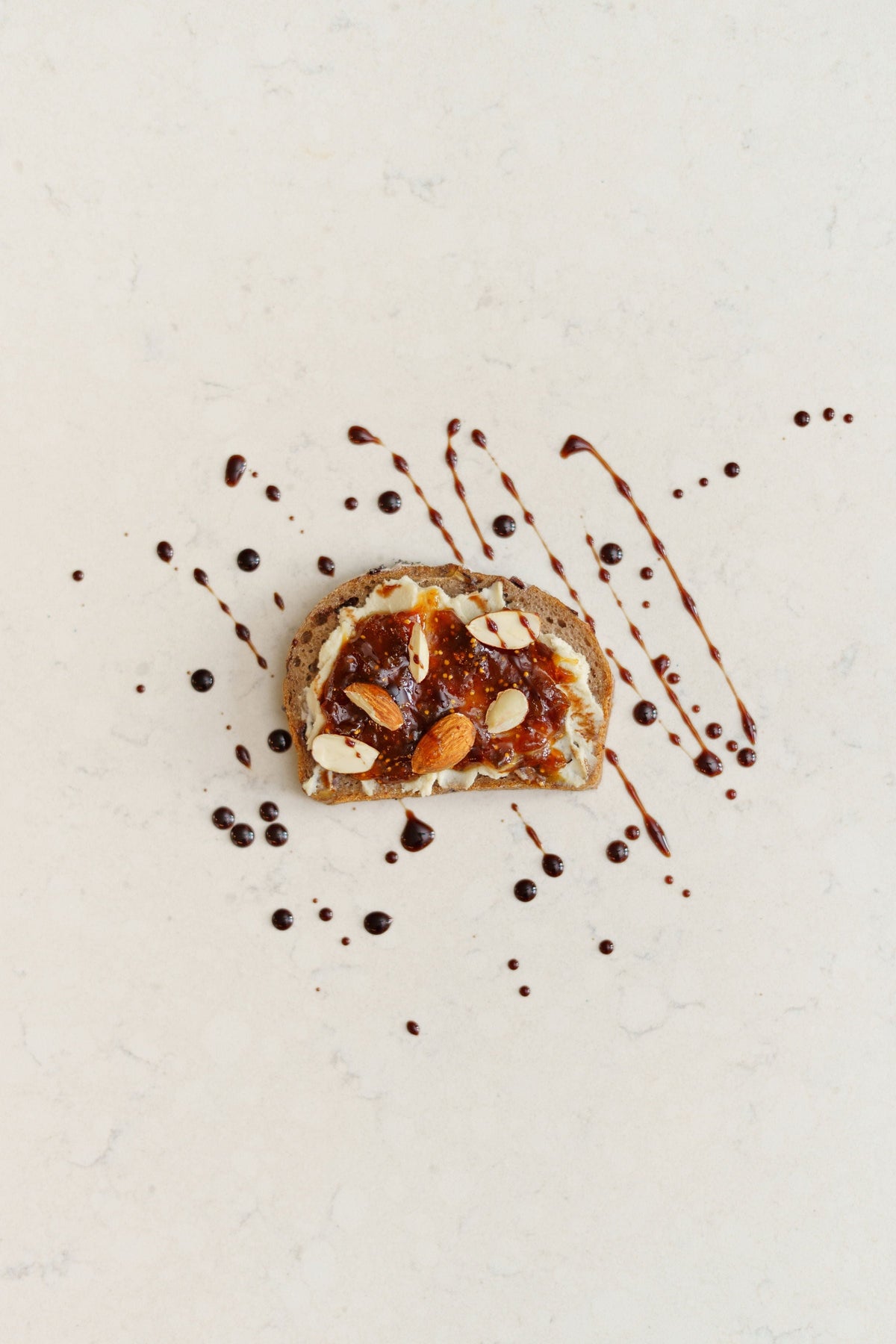 Four vegan sourdough loaves with cranberries and pecans from Heaven GF Bakery, showing crusty bread with fruit and nut toppings.