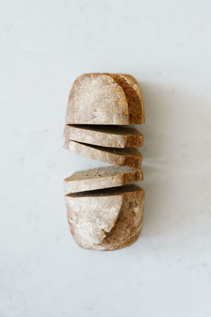 Four slices of Heaven GF Bakery vegan multi-seed sourdough bread loaf, showing the crust and seeded interior.