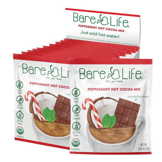 Open single-serving pack of Bare Life dairy-free peppermint hot cocoa mix, gluten-free, vegan, and organic.