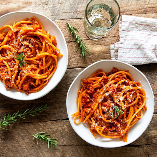 Jovial Gluten Free Brown Rice Bucatini pasta with sausage ragu in a bowl, showcasing the gluten-free pasta's texture and dish presentation.