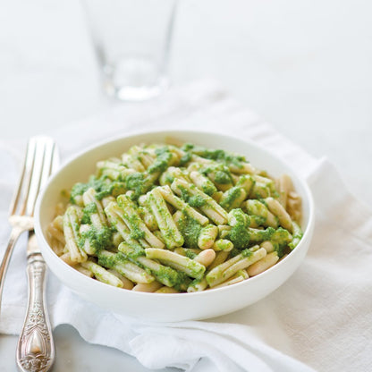 Jovial Gluten-Free Brown Rice Caserecce pasta with fresh arugula pesto on a plate, showcasing the pasta's texture and vibrant green sauce