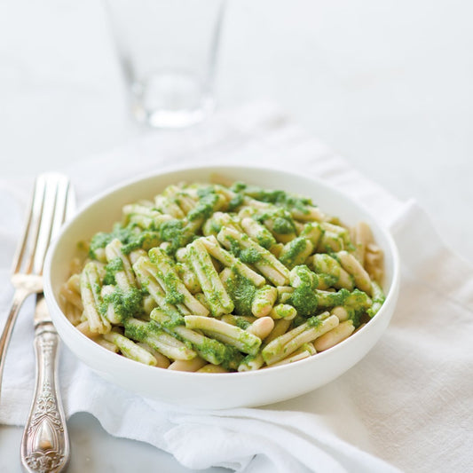 Jovial Gluten-Free Brown Rice Caserecce pasta with fresh arugula pesto on a plate, showcasing the pasta's texture and vibrant green sauce
