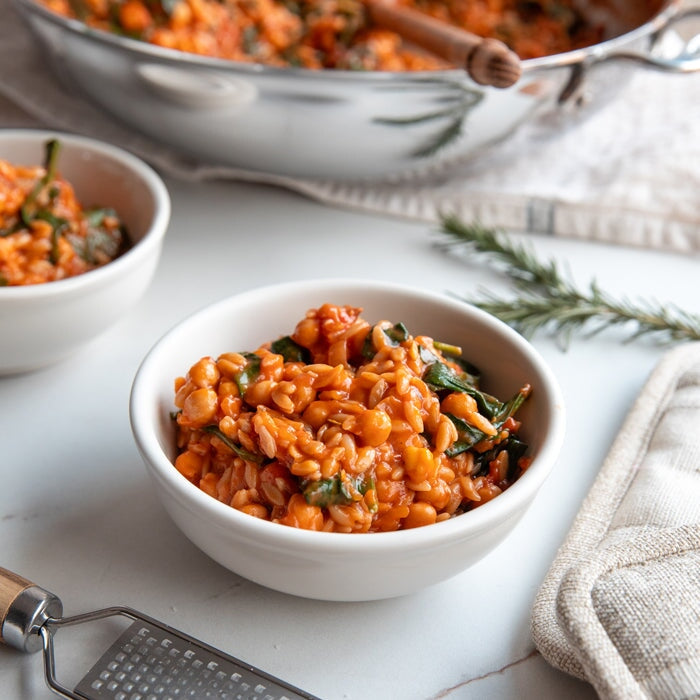 Jovial Gluten Free Brown Rice Orzo pasta with tomato and chickpeas in a bowl, showcasing the gluten-free product from Jovial Foods.