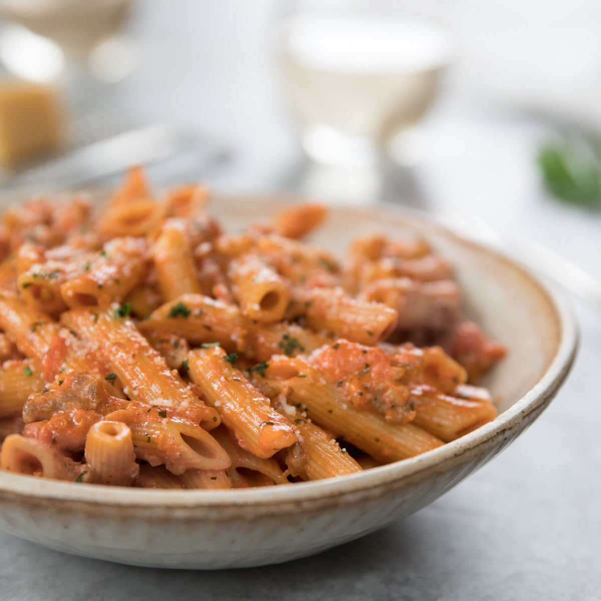 Gluten-free brown rice penne rigate pasta by Jovial Foods, Inc, showing cooked pasta with ridged surface and golden-brown color.