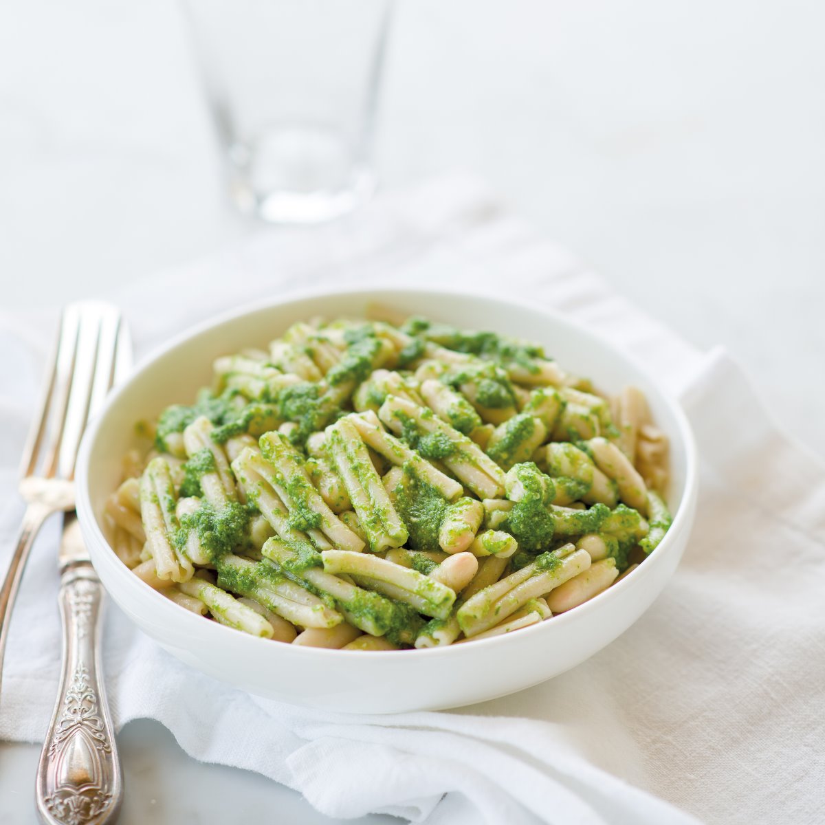 Jovial Gluten-Free Brown Rice Caserecce pasta with fresh arugula pesto on a plate, showcasing the pasta's texture and vibrant green sauce